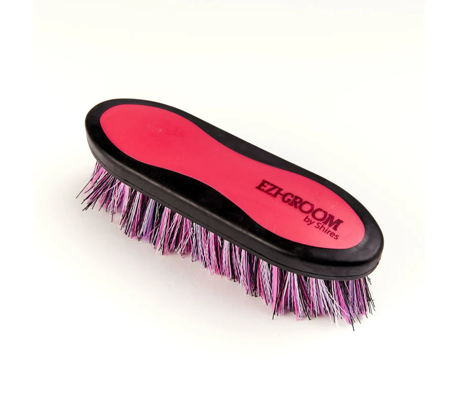 Pink grooming brush with 'Ezi-Groom' branding on a white background