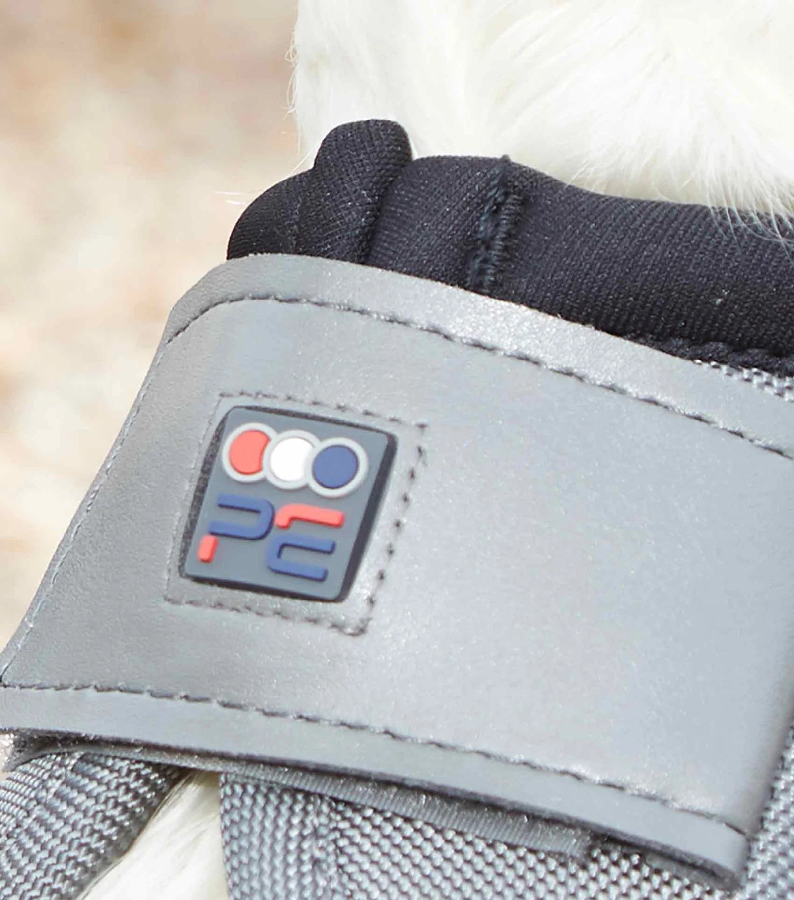 Close up of PE branding on grey overreach boot