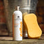 Bottle of Carr & Day & Martin shampoo with a yellow sponge and metal bucket in the background