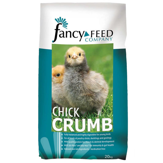 Bag of Fancy Feed Company Chick Crumb with chicks on a grassy background