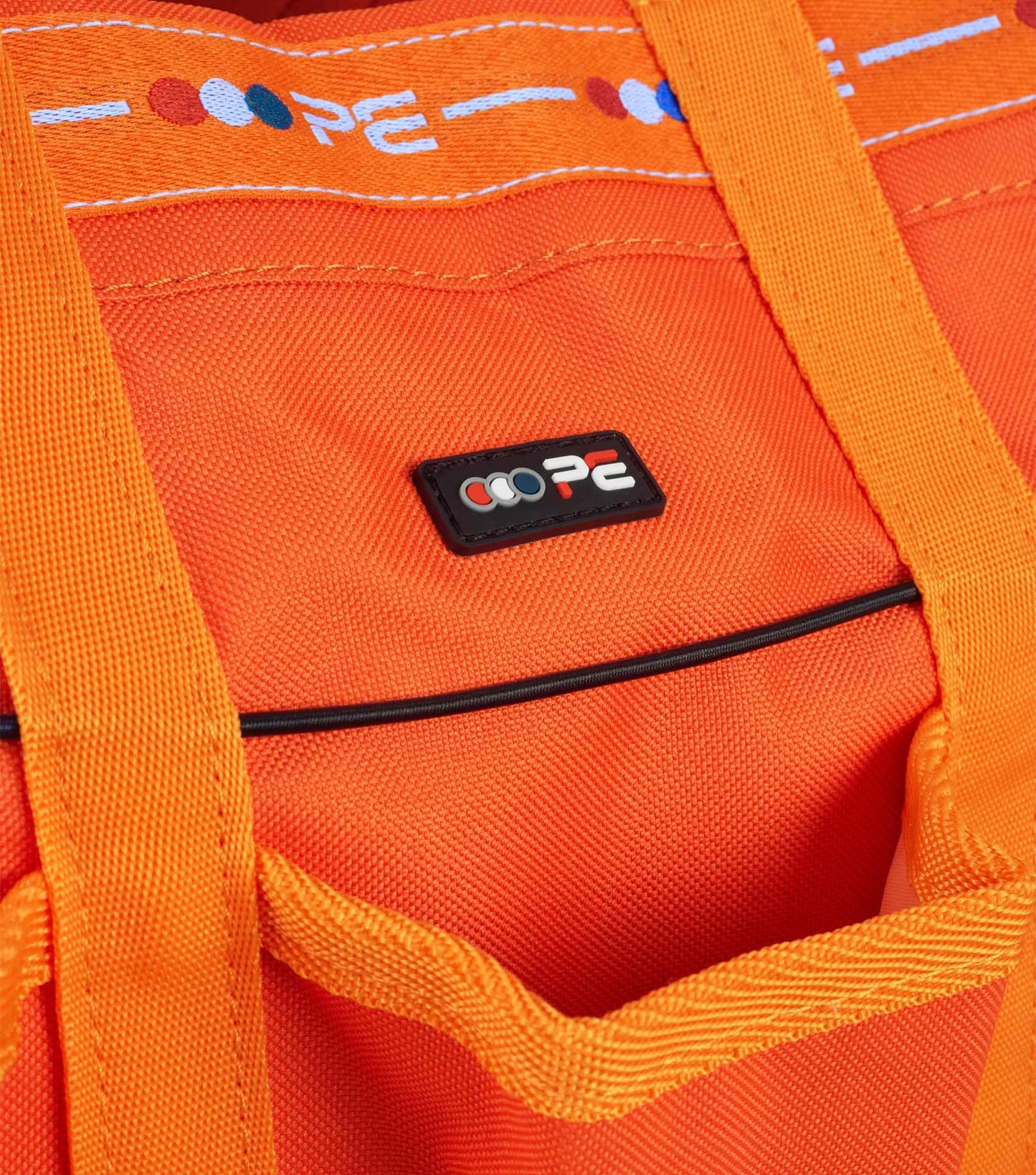 Close-up of an orange bag with Premier Equine brand logo on a matching background