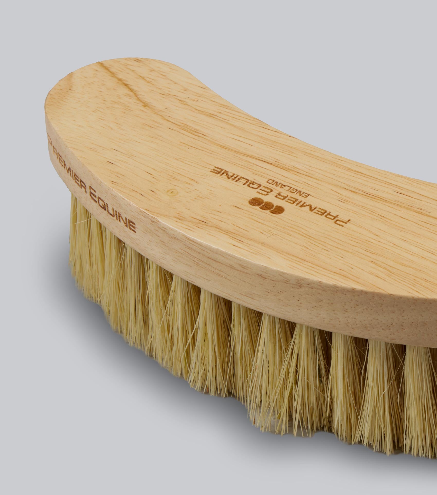 Wooden brush with bristles on a gray background