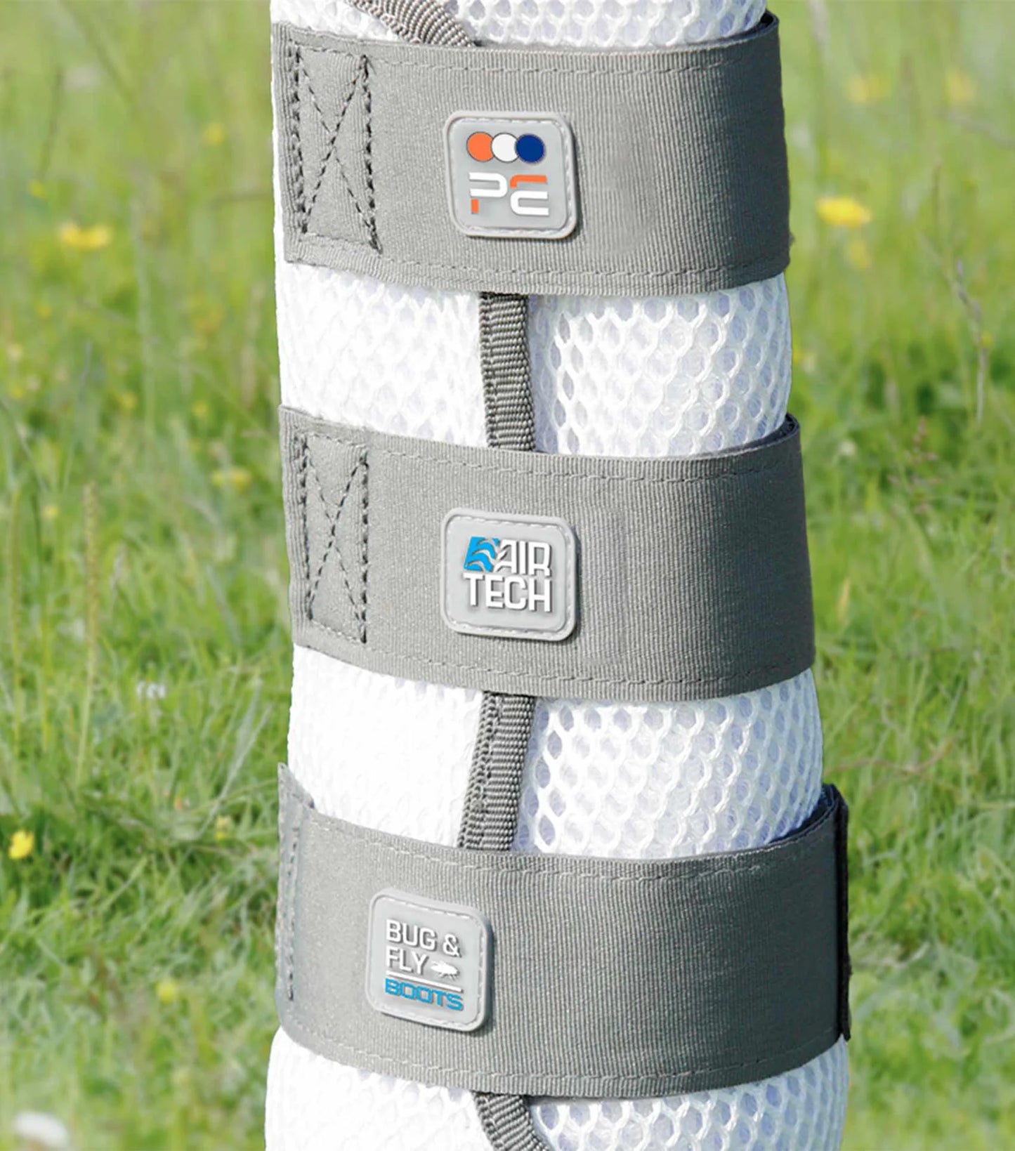Gray protective leg wrap with brand logos on a grassy background
