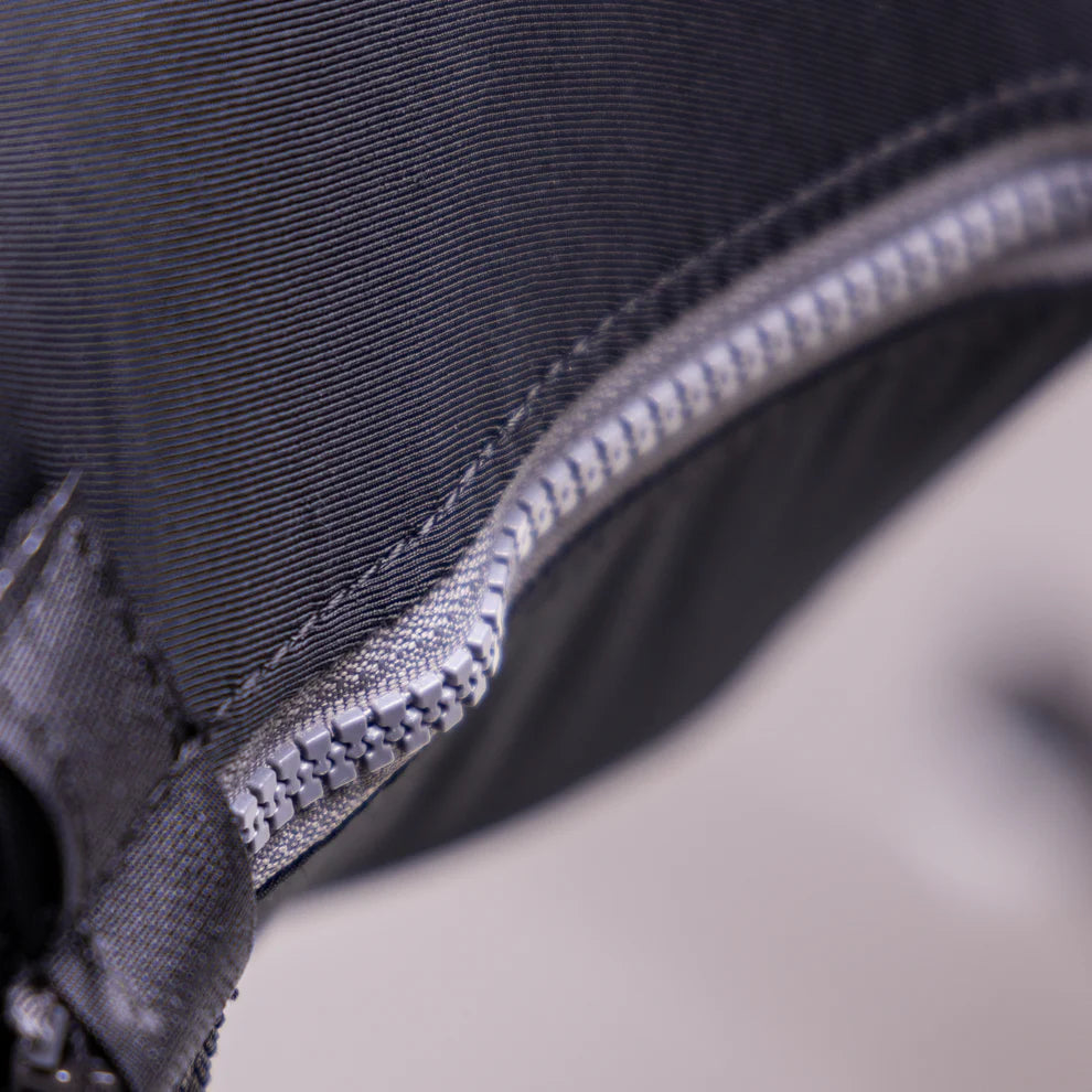 Close-up of a zipper on a black fabric surface