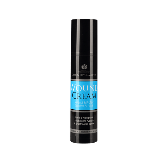 Black  container of wound cream with blue label on a black background