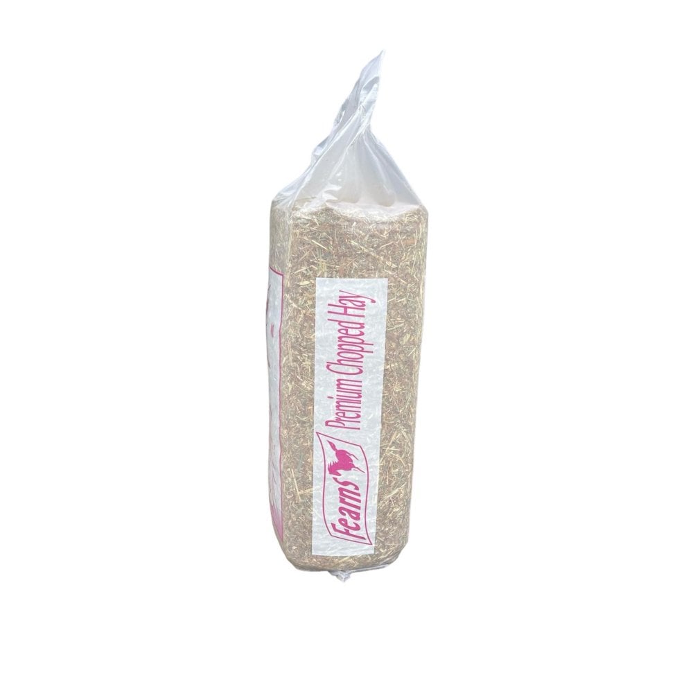 A package of Fearns Premium Chopped Hay, showing the light tan hay through a clear plastic bag with a white and pink label.