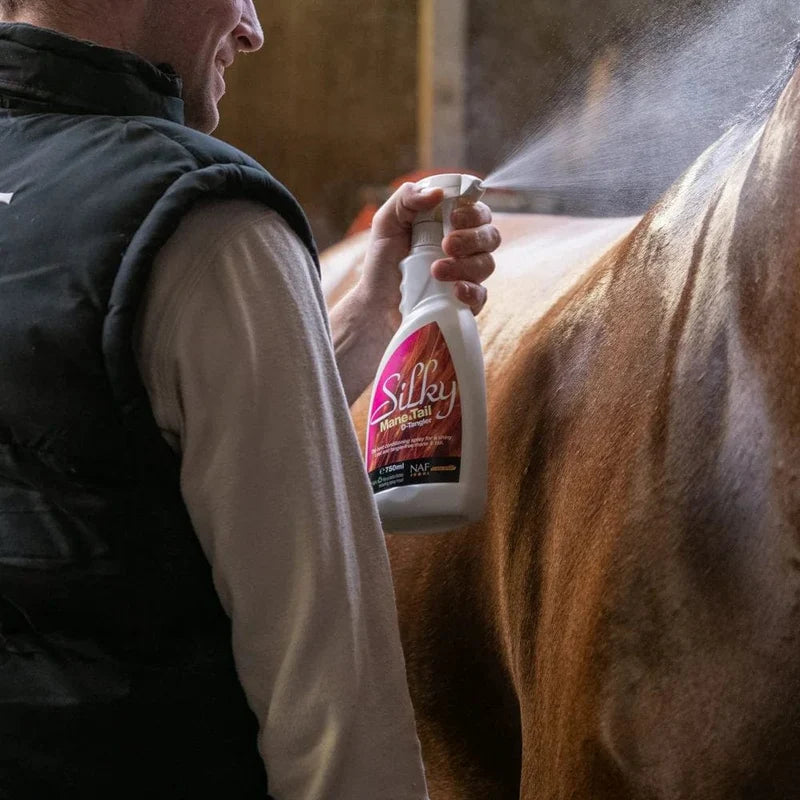 NAF Silky Mane & Tail D-Tangler spray bottle being applied to horse